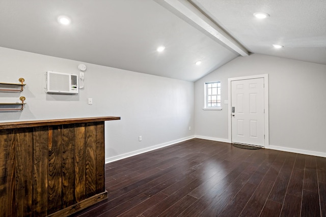 interior space with lofted ceiling with beams, baseboards, a wall mounted air conditioner, and wood finished floors