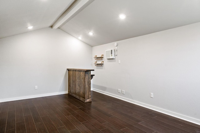 interior space with baseboards, a dry bar, vaulted ceiling with beams, and wood finished floors