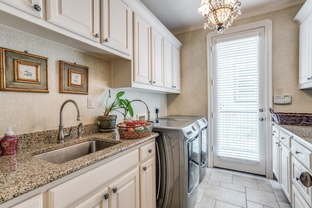 4592 Biltmoore Dr, Frisco, TX 75034 - laundry room featuring independent washer and dryer, cabinet space, a chandelier, light tile patterned floors, and crown molding