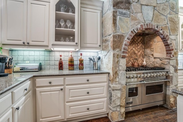 4592 Biltmoore Dr, Frisco, TX 75034 - kitchen featuring range with two ovens, glass insert cabinets, light stone counters, white cabinets, and tasteful backsplash