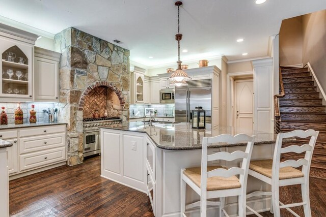 4592 Biltmoore Dr, Frisco, TX 75034 - kitchen featuring built in appliances, glass insert cabinets, backsplash, a sink, and ornamental molding