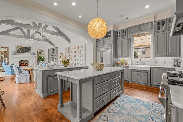 kitchen featuring gray cabinetry, an inviting chandelier, and a kitchen island