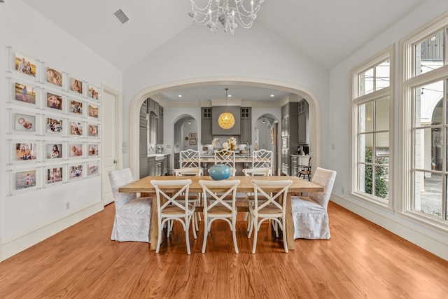 dining area with arched walkways, a healthy amount of sunlight, and visible vents