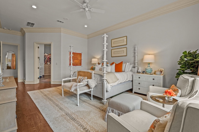 bedroom featuring ornamental molding, visible vents, and wood finished floors