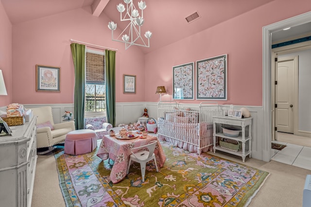interior space featuring lofted ceiling with beams, visible vents, a notable chandelier, and wainscoting