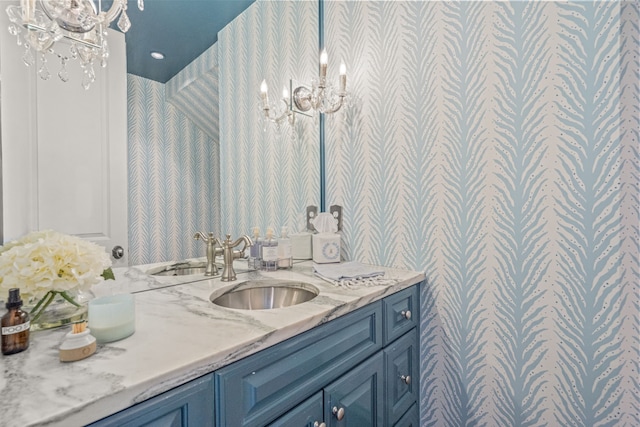 bathroom with vanity and a chandelier