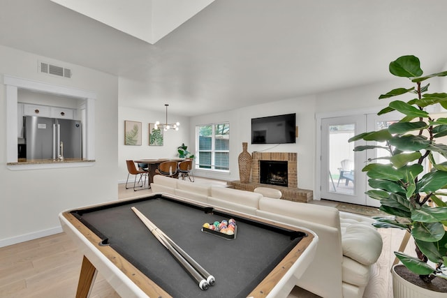 9231 Chimney Corner Ln, Dallas, TX 75243 - playroom featuring billiards, visible vents, light wood-type flooring, baseboards, and a brick fireplace