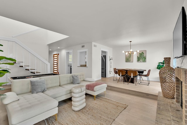 9231 Chimney Corner Ln, Dallas, TX 75243 - living area with stairway, wood finished floors, and a chandelier