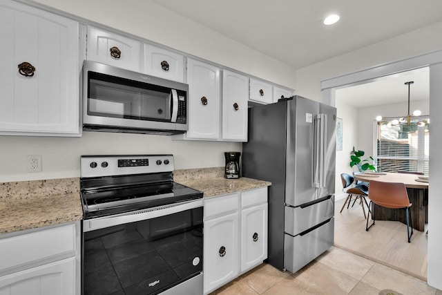9231 Chimney Corner Ln, Dallas, TX 75243 - kitchen with appliances with stainless steel finishes, white cabinetry, a chandelier, light tile patterned flooring, and recessed lighting