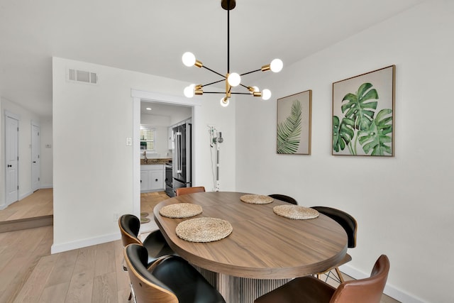 9231 Chimney Corner Ln, Dallas, TX 75243 - dining room featuring a chandelier and light wood-style floors