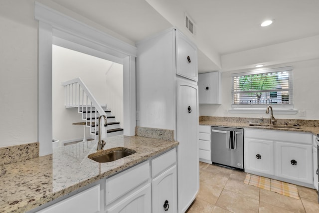 9231 Chimney Corner Ln, Dallas, TX 75243 - kitchen with dishwasher, white cabinets, recessed lighting, and light stone countertops
