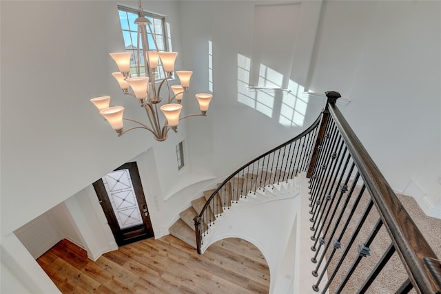 409 Horizon Way, Northlake, TX 76247 - stairs with wood finished floors, a high ceiling, and an inviting chandelier