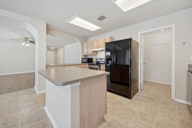 kitchen featuring black appliances, light brown cabinets, under cabinet range hood, arched walkways, and ceiling fan