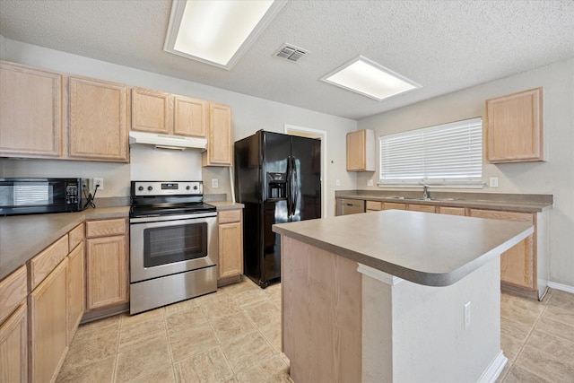 kitchen with black appliances, light brown cabinetry, under cabinet range hood, a textured ceiling, and a center island