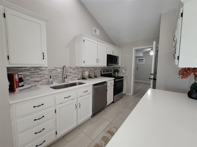 608 Concho Dr, Oak Point, TX 75068 - kitchen featuring appliances with stainless steel finishes, tasteful backsplash, lofted ceiling, white cabinetry, and light countertops