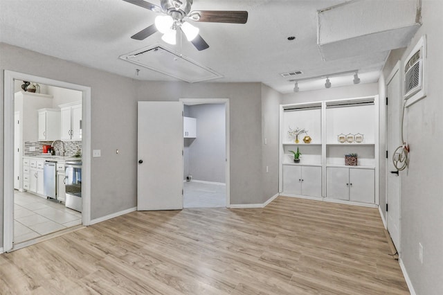 608 Concho Dr, Oak Point, TX 75068 - spare room with attic access, a ceiling fan, light wood-style flooring, and a wall mounted air conditioner