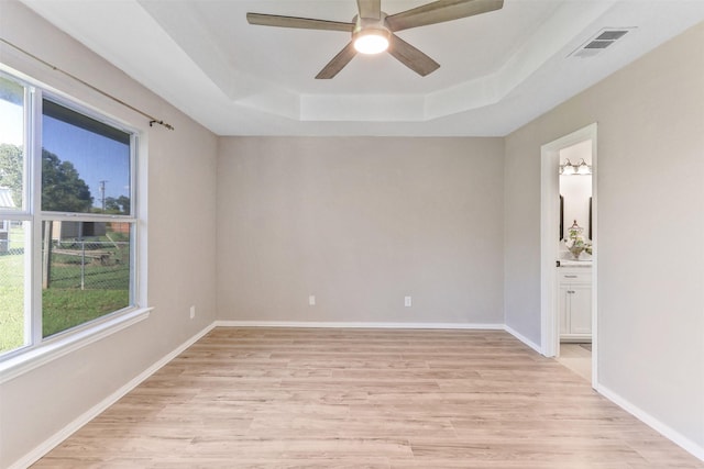 608 Concho Dr, Oak Point, TX 75068 - empty room with a raised ceiling, healthy amount of natural light, and light wood-style flooring