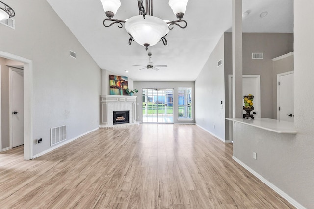 608 Concho Dr, Oak Point, TX 75068 - unfurnished living room featuring ceiling fan, light wood-type flooring, a fireplace, and high vaulted ceiling