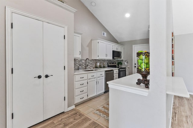 608 Concho Dr, Oak Point, TX 75068 - kitchen featuring stainless steel appliances, light countertops, white cabinetry, backsplash, and lofted ceiling