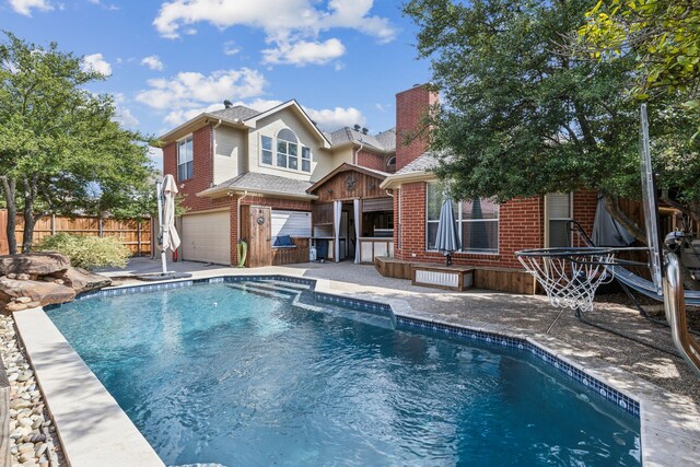 4597 Old Pond Dr, Plano, TX 75024 - rear view of property with a chimney, a fenced in pool, brick siding, fence, and an attached garage