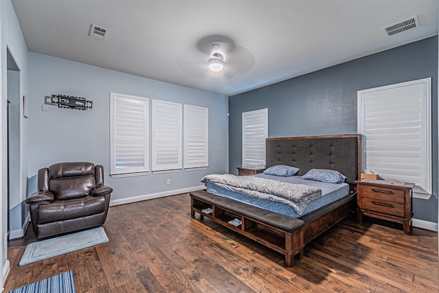 bedroom featuring hardwood / wood-style floors, baseboards, visible vents, and a ceiling fan