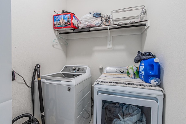 washroom with washing machine and dryer and laundry area