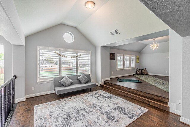 sitting room with visible vents, lofted ceiling, and hardwood / wood-style floors