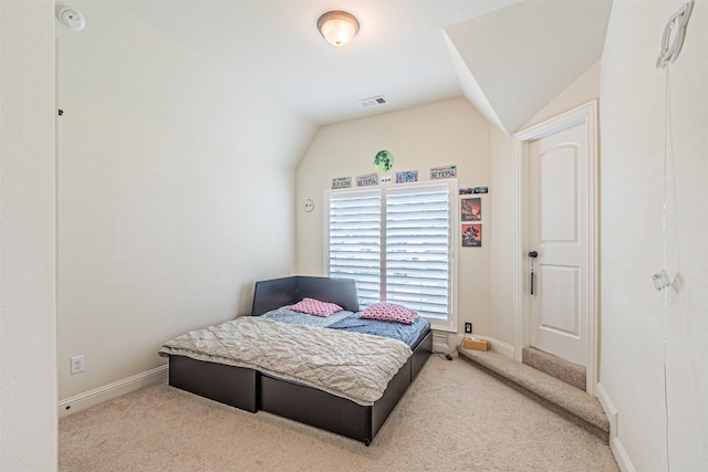 carpeted bedroom with baseboards, vaulted ceiling, and visible vents