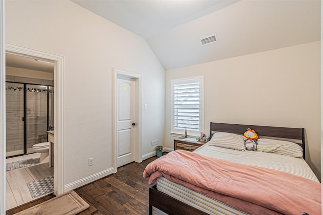 bedroom featuring lofted ceiling, baseboards, connected bathroom, dark wood-style floors, and visible vents