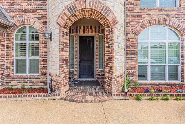 property entrance with brick siding