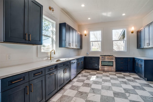 kitchen featuring a sink, recessed lighting, light countertops, and appliances with stainless steel finishes