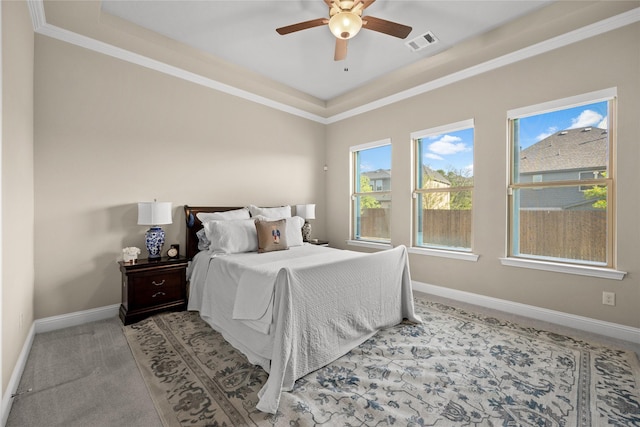 bedroom featuring a tray ceiling, ornamental molding, visible vents, carpet flooring, and baseboards