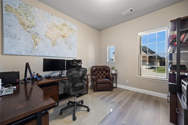 office area featuring visible vents, baseboards, and wood finished floors
