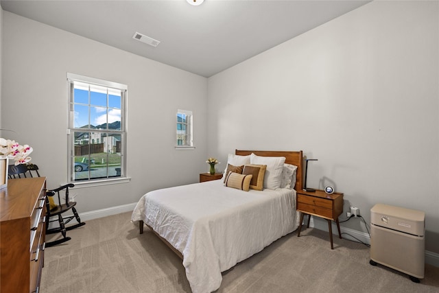 bedroom with visible vents, baseboards, and carpet