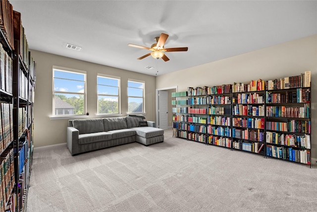living area featuring ceiling fan, baseboards, carpet, and visible vents