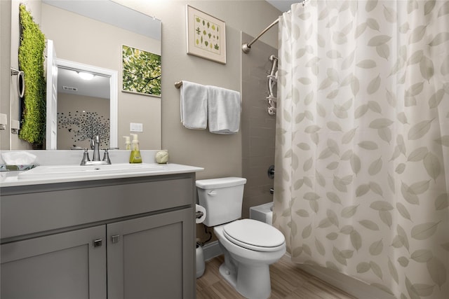 bathroom featuring visible vents, toilet, shower / bathtub combination with curtain, and vanity