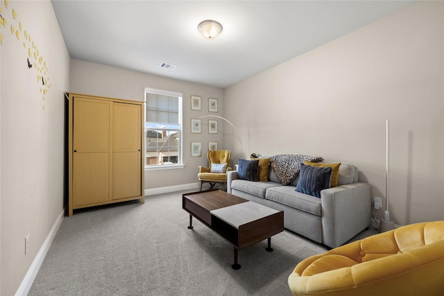 living area with visible vents, baseboards, and light carpet