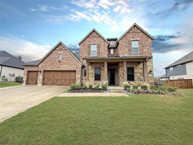 view of front facade featuring stone siding, covered porch, a garage, concrete driveway, and a front lawn