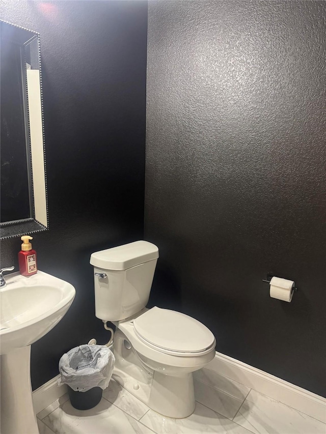 2416 Grand Rapids Dr, Fort Worth, TX 76177 - bathroom with marble look tile flooring, toilet, and baseboards