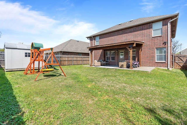 2416 Grand Rapids Dr, Fort Worth, TX 76177 - rear view of house with brick siding, a patio, a playground, and an outbuilding