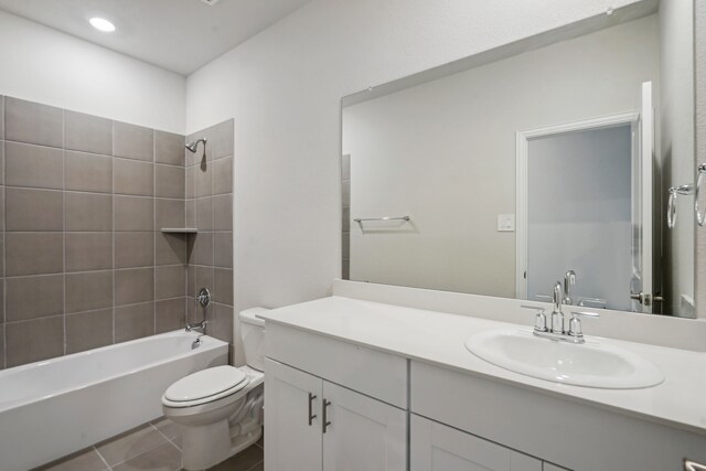 bathroom featuring toilet, vanity, shower / bath combination, and tile patterned flooring