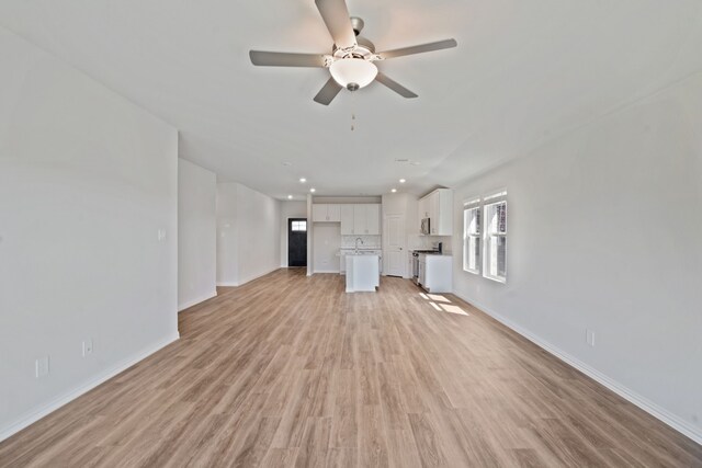 unfurnished living room featuring baseboards, ceiling fan, recessed lighting, and light wood-type flooring