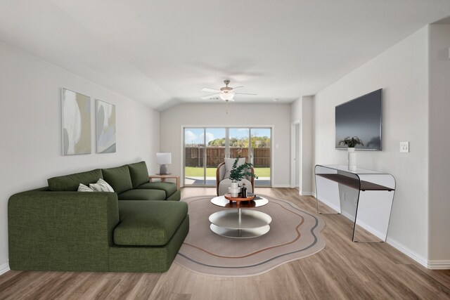 living room featuring wood finished floors, baseboards, lofted ceiling, and ceiling fan