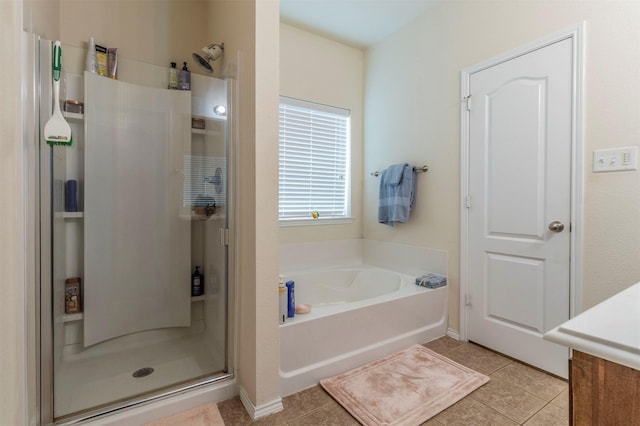 1129 Hidden Lake Dr, Burleson, TX 76028 - full bathroom featuring a shower stall, a garden tub, baseboards, and tile patterned flooring