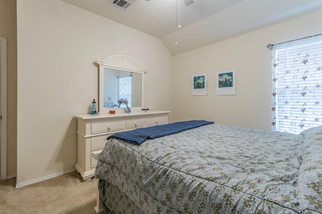 bedroom with ceiling fan, light colored carpet, vaulted ceiling, visible vents, and baseboards