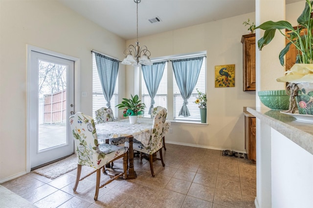 dining space featuring visible vents, baseboards, a chandelier, and light tile patterned floors