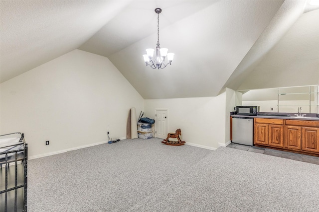 5 Pamela Ct, Mansfield, TX 76063 - bonus room featuring a notable chandelier, a sink, lofted ceiling, baseboards, and light colored carpet