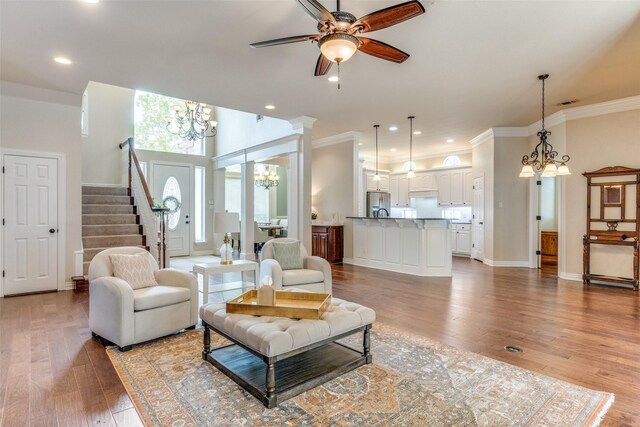 5 Pamela Ct, Mansfield, TX 76063 - living room featuring crown molding, light wood finished floors, baseboards, stairs, and ceiling fan with notable chandelier
