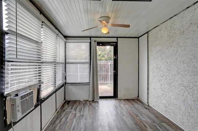 empty room featuring ceiling fan, wooden ceiling, wood finished floors, and cooling unit