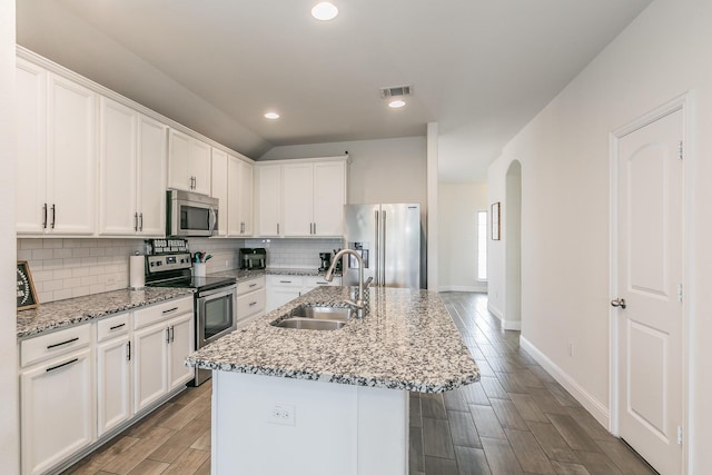 kitchen with white cabinets, visible vents, stainless steel appliances, and a sink